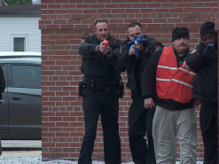 Officer William Old, III (second from left, holding blue training prop rifle) with other responders on Feb. 11. (Photo by Mike Gooding, WVEC TV-13)