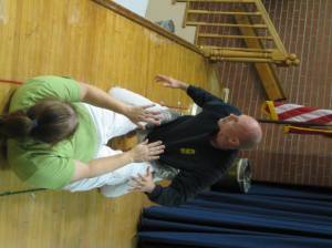 Jen Taylor, an instructor at Norfolk Karate Academy, throws off Master Instructor Bill Odom during a demonstration  at the January 9th, 2012 Suburban Acres Civic League Meeting.